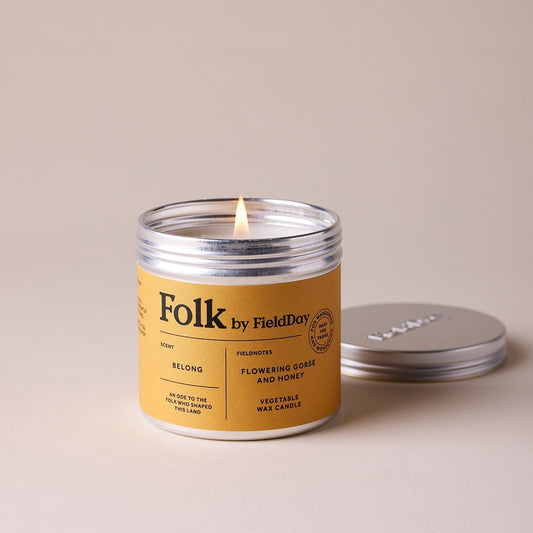 Folk by Field Day candle with a lit wick on a beige background