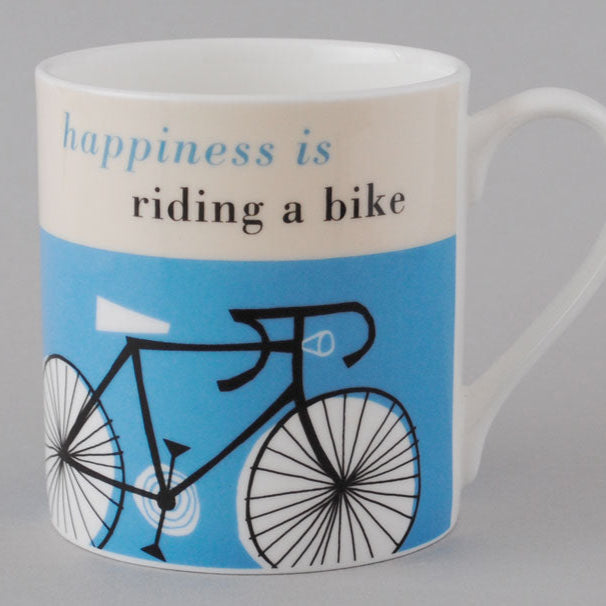 Mug with bicycle design and text 'happiness is riding a bike'