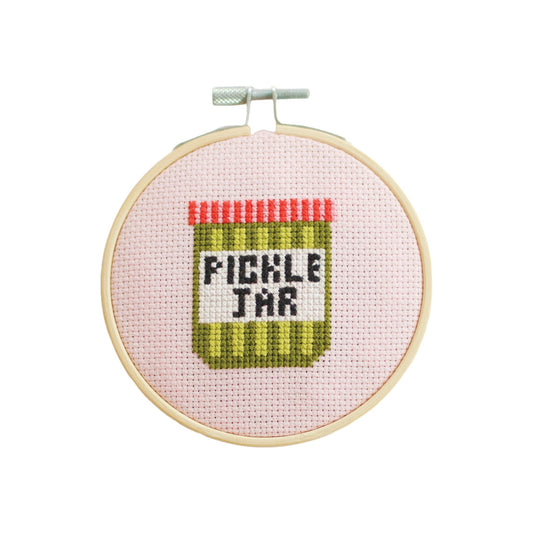 Cross-stitched pickle jar design craft kit with a wooden hoop.