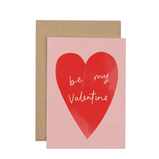 Greeting card with red heart and 'be my Valentine' text on pink background