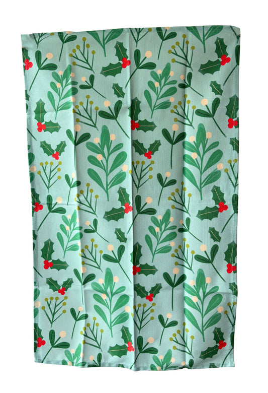 Festive fabric with holly leaf and berry pattern on a light blue background