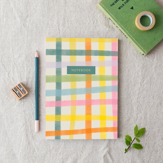 A colorful gingham A5 notebook with the word 'NOTEBOOK' written on the front, made in Britain from bleed proof, eco-friendly, recycled paper with 100gsm inner pages.