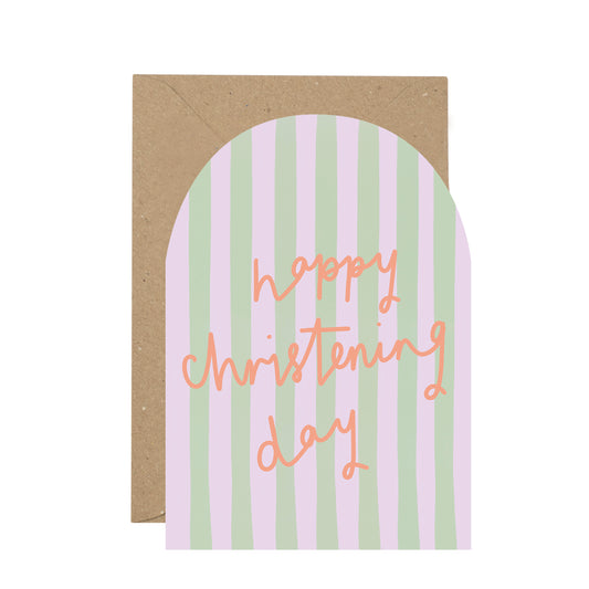 Greeting card with 'Happy Christening Day' text on a striped design with a brown envelope.