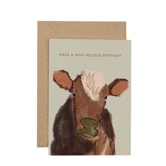 Greeting card with a cow illustration and 'Have a moo-velous birthday' text, featuring a brown envelope.
