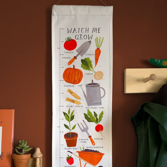 Growth chart with gardening-themed illustrations on