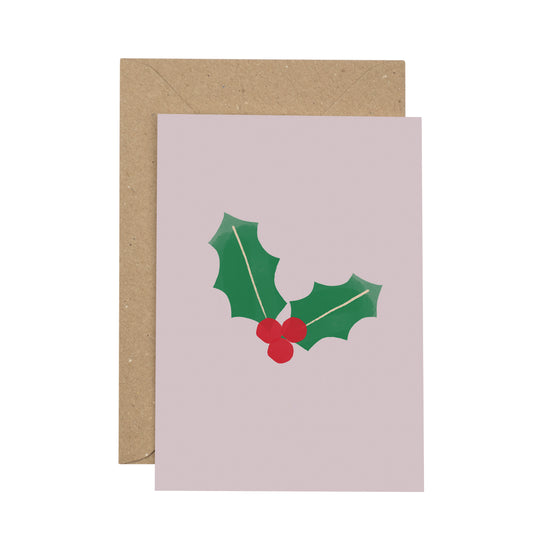 Greeting card with holly design and brown envelope on white background