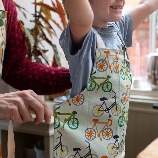Bicycle design kids apron with adjustable neck strap.