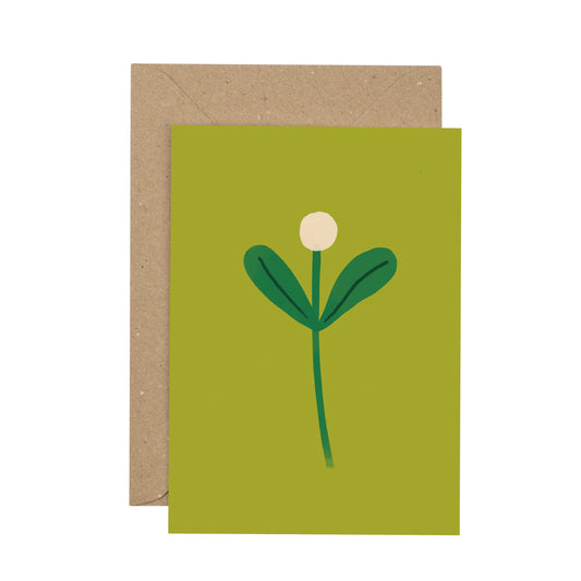 Green greeting card with a white flower design and brown envelope on a white background