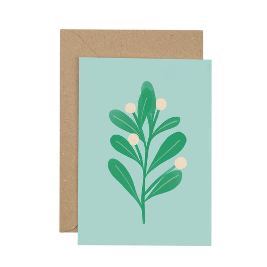 Card with mistletoe design on a light blue background, featuring a brown envelope.