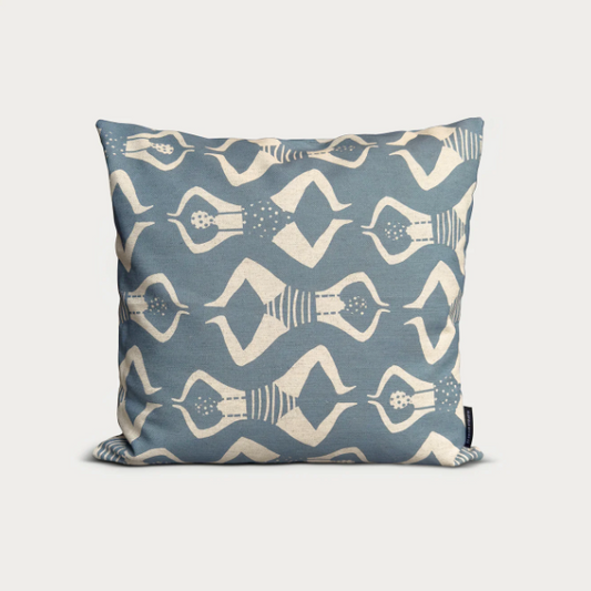 Decorative pillow with swimmers pattern on a light grey background