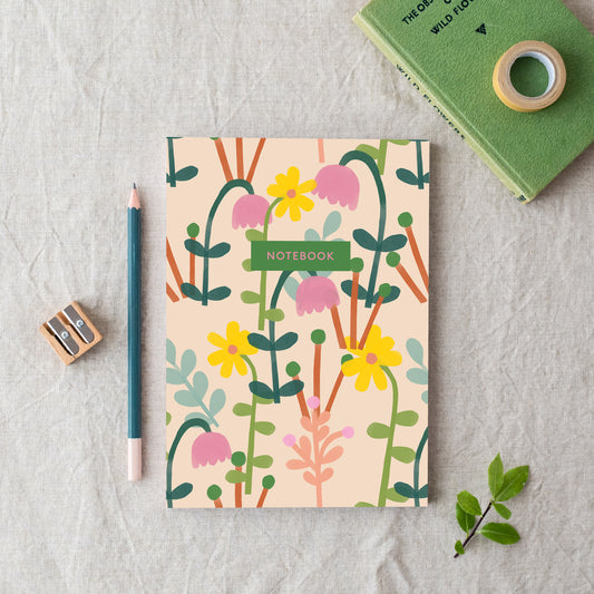 An A5 notebook with a floral pattern, made in Britain from bleed proof, eco-friendly, recycled paper with 100gsm inner pages.