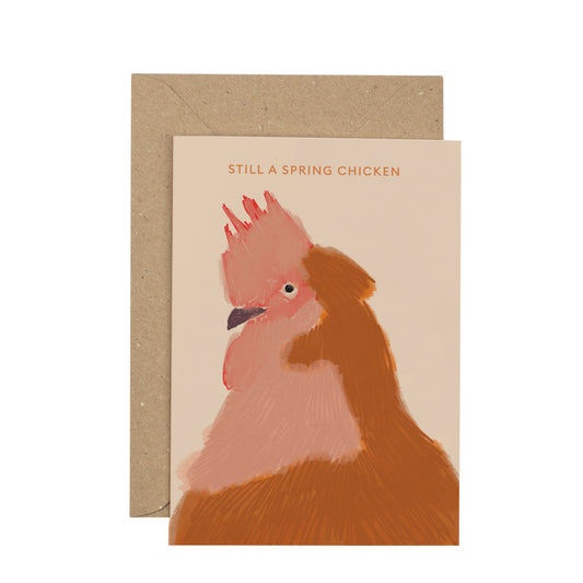 Card with a chicken illustration and text 'Still a Spring Chicken' on a beige background