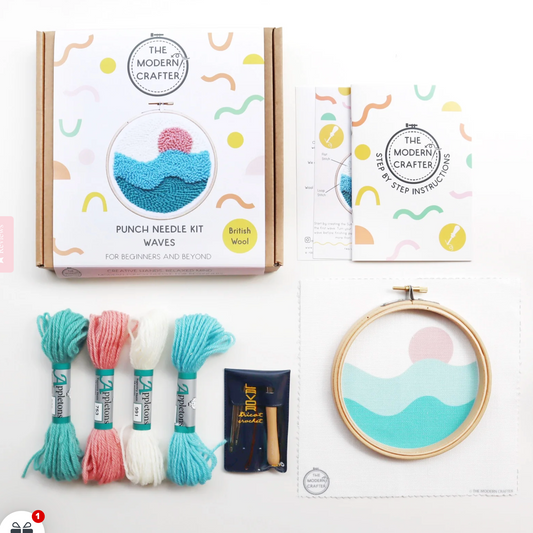 Punch needle kit with yarn and embroidery hoop on a white background