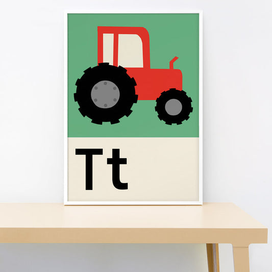 Poster with a red tractor on a green background, featuring the letter 'T' below it, displayed on a table.