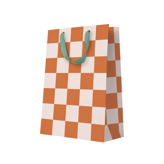 Checkered paper bag with green handles on a white background