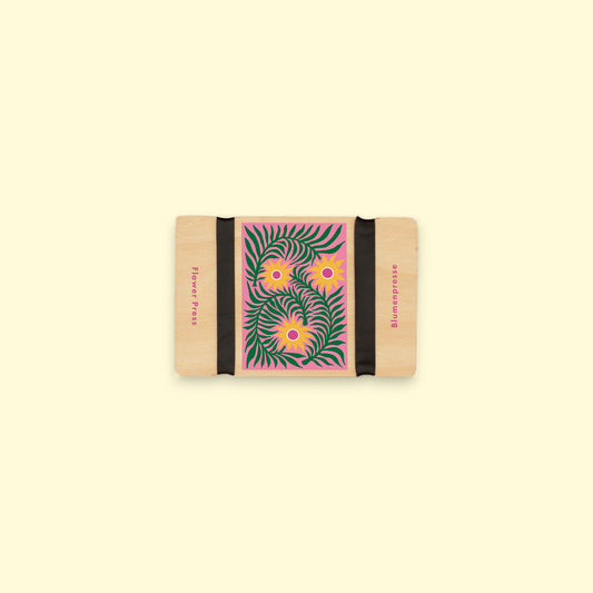 Rectangular Mini flower press with floral design on a beige background