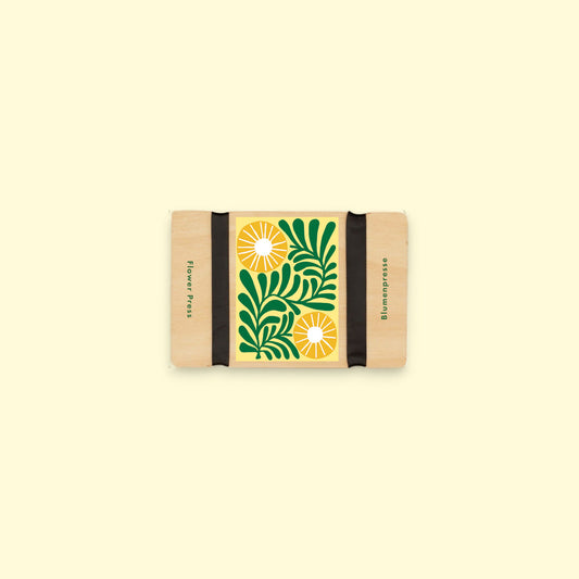 Small flower press with vine flower design on a beige background