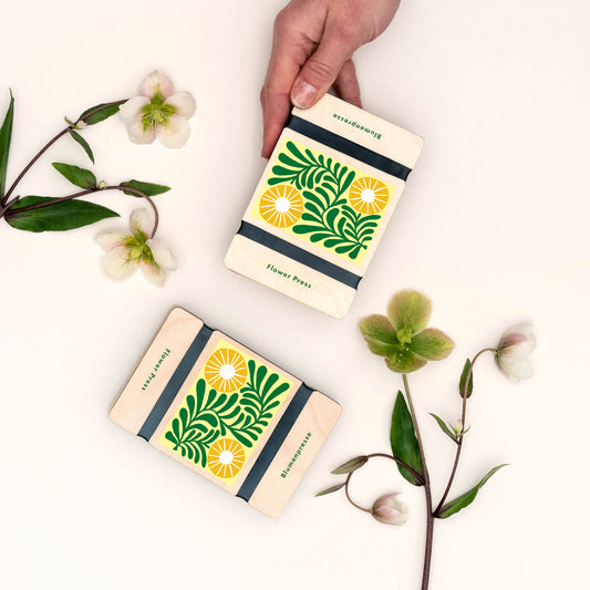 flower press with vine design on beige background 