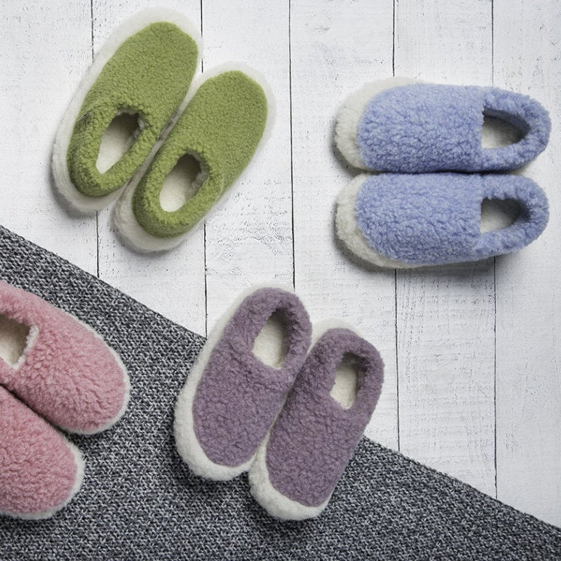Set of colorful slippers on a wooden floor