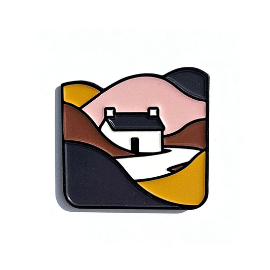 Sculptural art piece of a house on a hill with abstract design