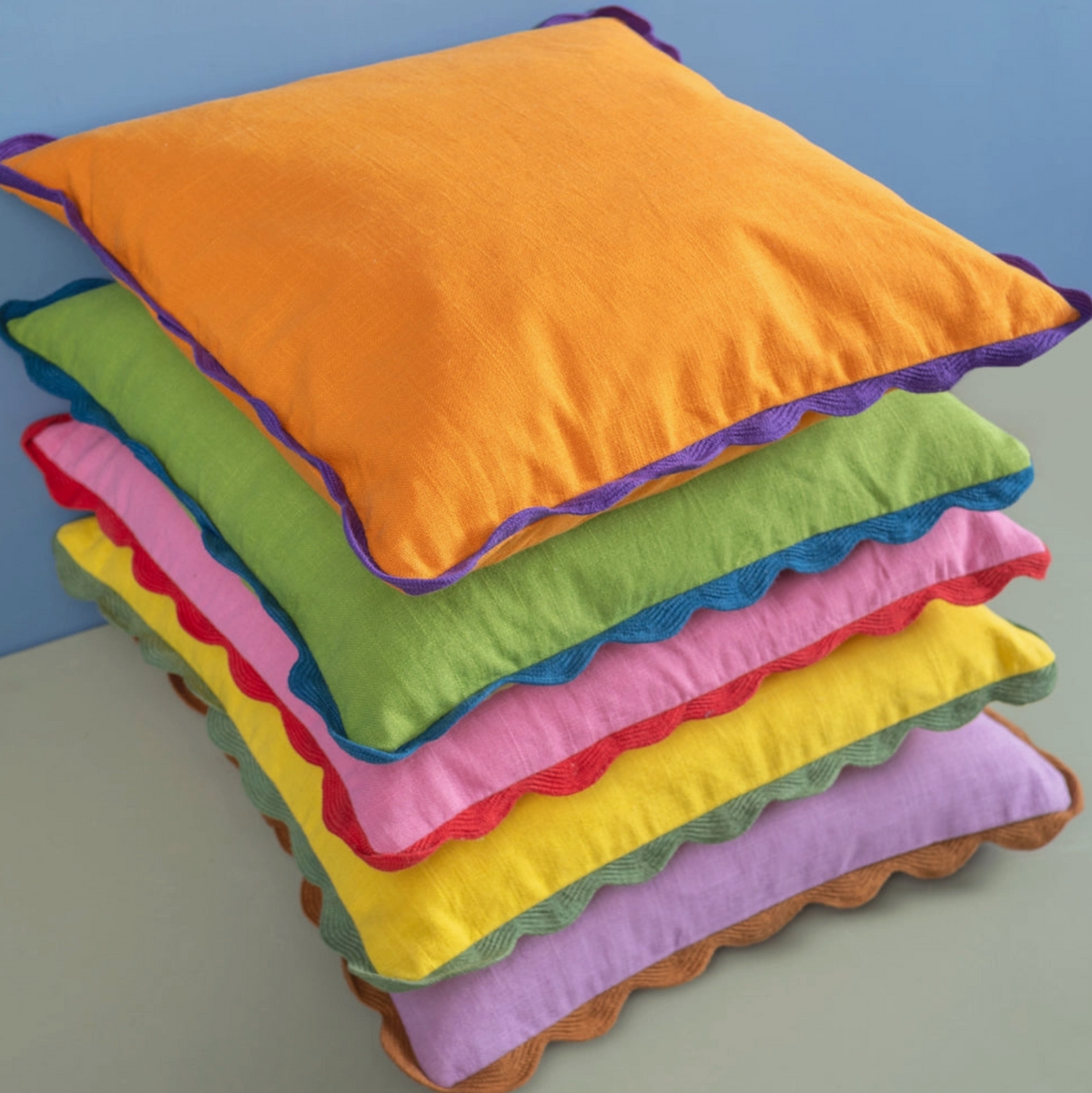 block colour cushions stacked in a pile