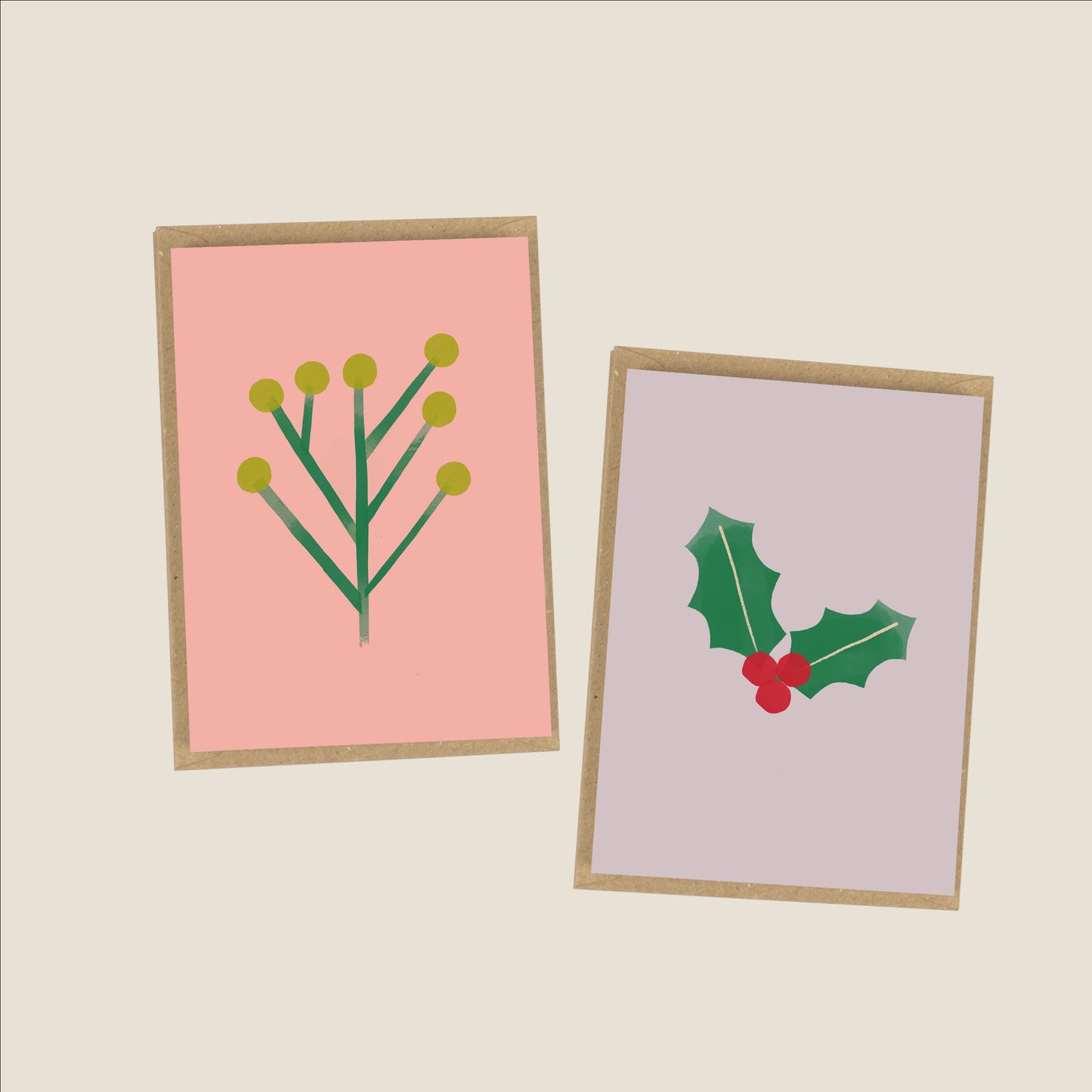 an image of two christmas cards in pink and purple, with botanical holly illustrations