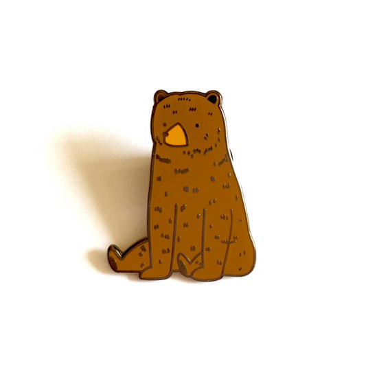 Small wooden bear figurine on a white background