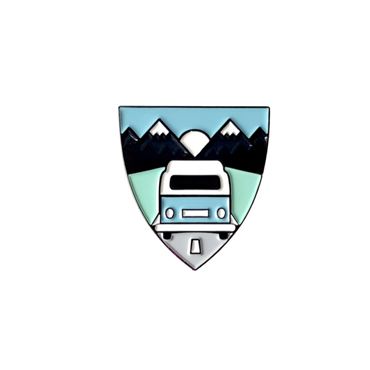 Badge with a camper van and mountain design on a white background