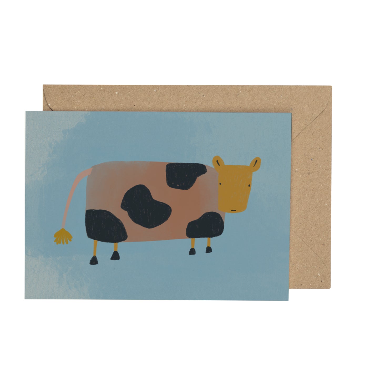 a tiny card with an illustration of a cow on a blue background with a brown envelope