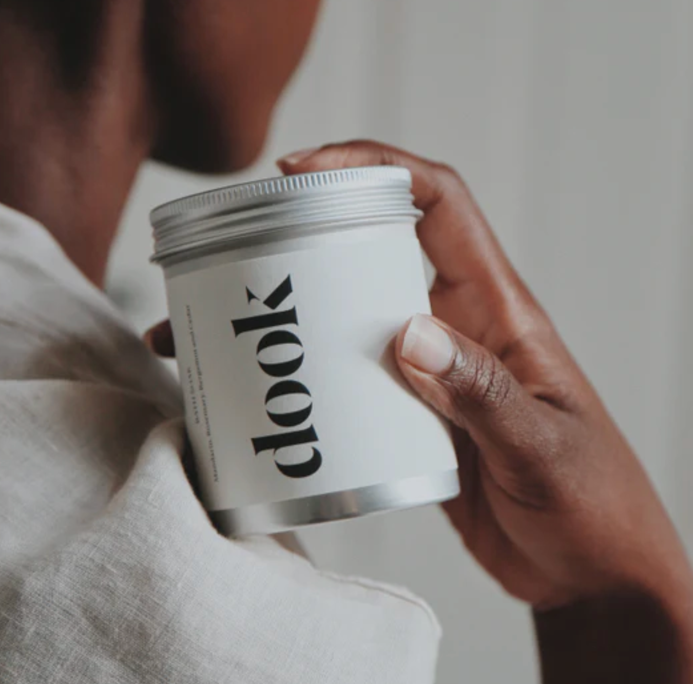 Person holding a white container with 'dook' branding.