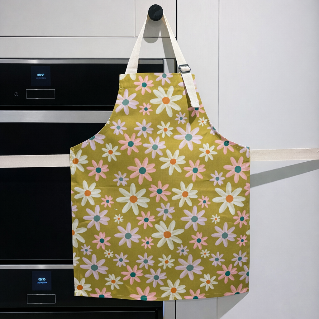 Floral apron hanging on a kitchen cabinet