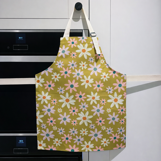 Floral apron hanging on a kitchen cabinet