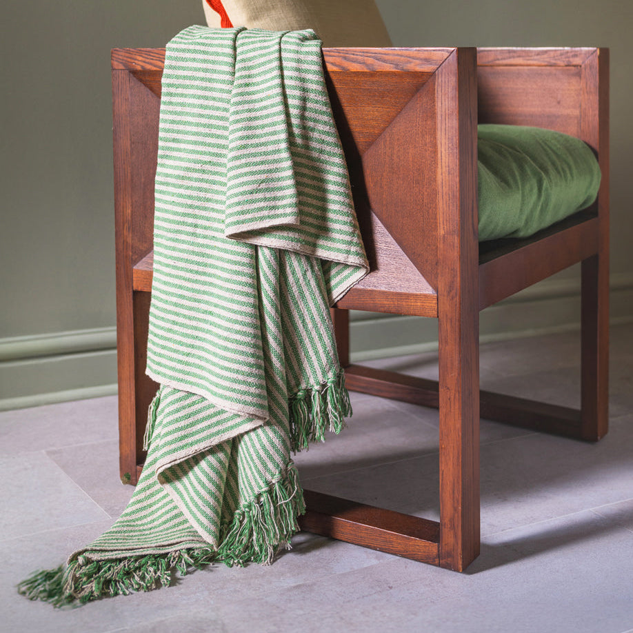 Wooden chair with a green striped throw
