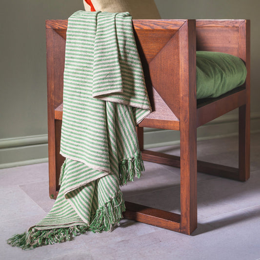 Wooden chair with a green striped throw