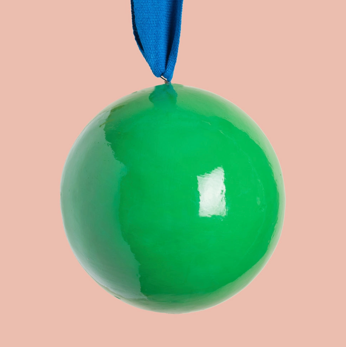 a large green round bauble made from recycled paper with a blue ribbon
