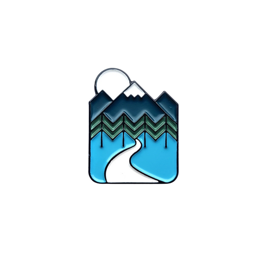 Pin badge with mountain and wave design on a white background