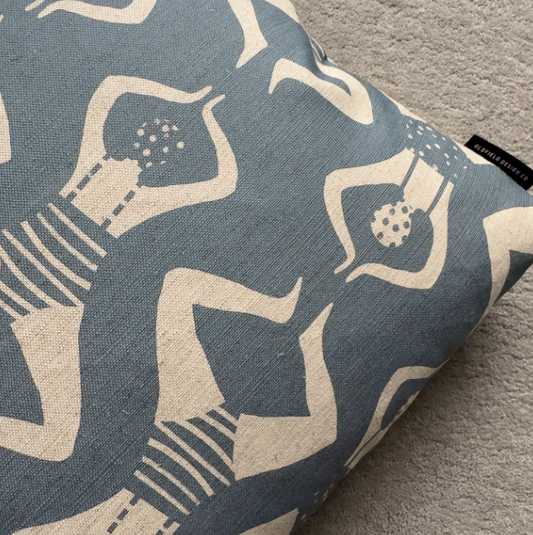 Decorative pillow with abstract pattern on a blue surface