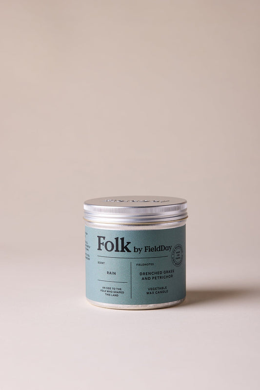 Tin candle jar labelled 'Folk by Field Day'  scent - rain