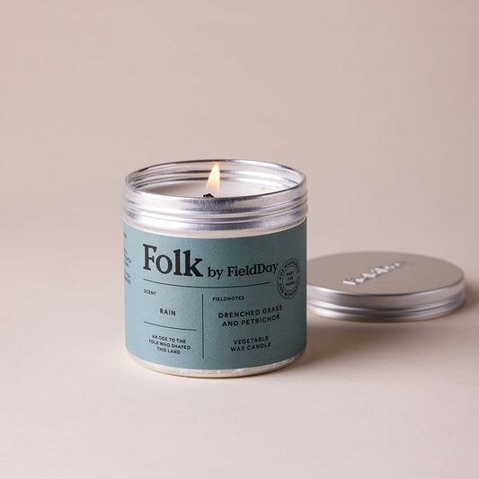 Candle with 'Folk by Field Day' label on a beige background