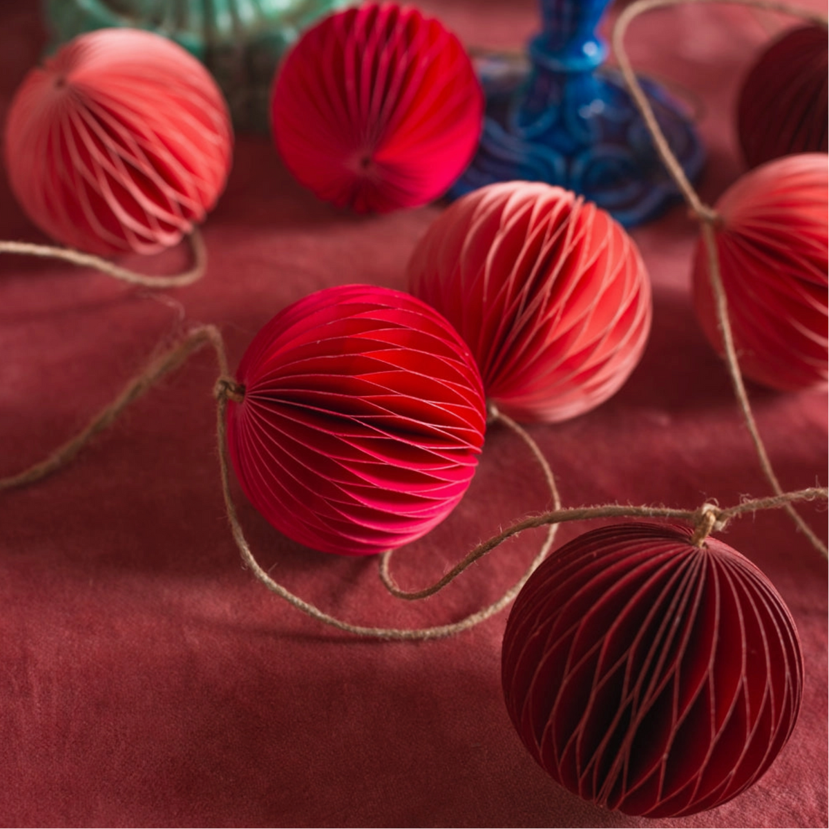 close up image of the pink and red origami garland