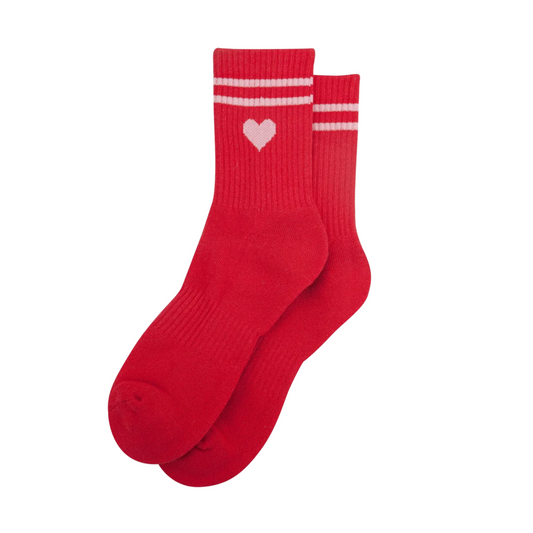 A pair of bright red crew socks with white stripes on the cuffs and a small white heart logo on the front sock, shown against a plain white background.