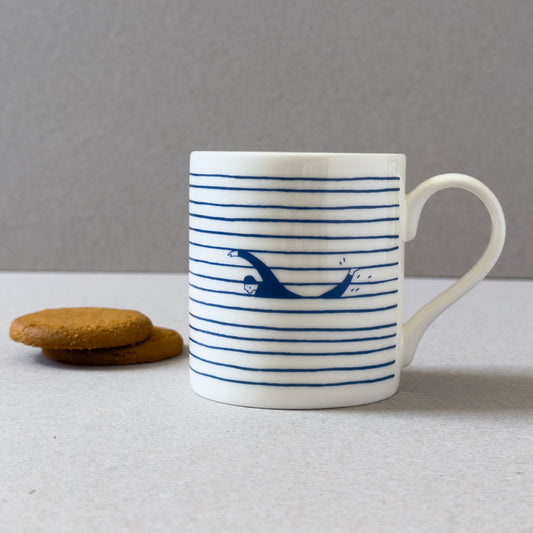 White mug with blue stripes and swimmer design 