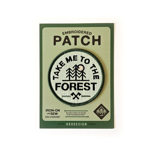 Embroidered patch with 'Take Me to the Forest' design on a green card